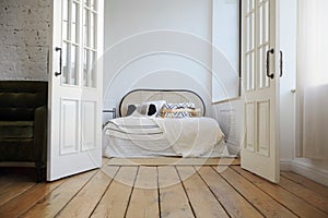Bedroom interior with wooden floor and white walls
