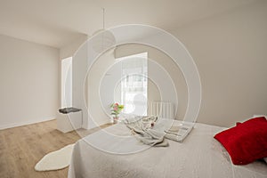 Bedroom with a king size bed with white walls and furniture, vegetal
