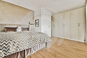 a bedroom with a large bed and white closets