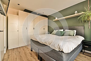 a bedroom with a large bed and white closets