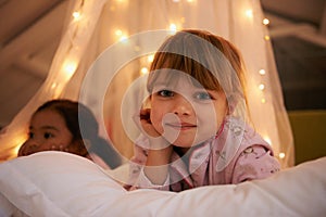Bedroom, lights and portrait of children at night for resting, relaxing and dreaming in home. Happy, smile and face of