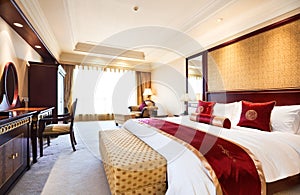 Bedroom of luxury suite in hotel photo