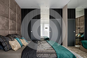 Bedroom with mirrored and upholstered walls