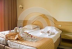 Bedroom in nice hotel with towels on bed