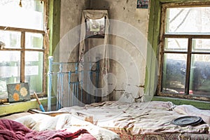 Bedroom in old cottage in abandoned village, Chernobyl Exclusion, Ukraine