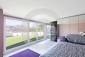 Bedroom overlooking the terrace with grass