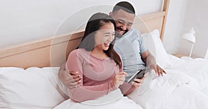 Bedroom, phone and couple laughing, relax and reading funny mobile app, meme joke or relationship humour story