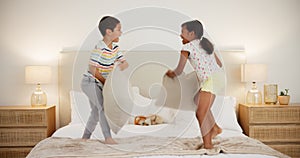 Bedroom, pillow fight and brother with sister, happiness and fun with entertainment and bonding together. Kids, boy or