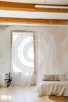 Bedroom in soft light colors with a wooden floor.