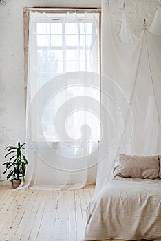 Bedroom in soft light colors with a wooden floor.