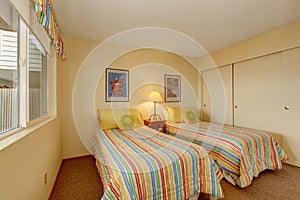 Bedroom with two single beds in cheerful bedding