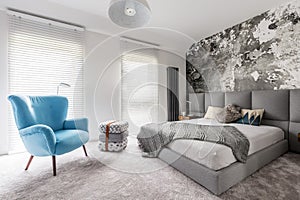 Bedroom with vintage blue armchair