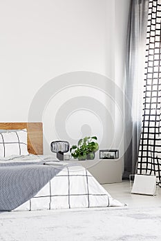 Bedroom with white wall and chequered bedding