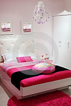 Bedroom with white wardrobe and pink carpet.