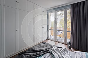 Bright bedroom with white wrdrobe