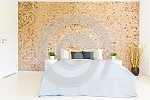 Bedroom with wooden mosaic wall