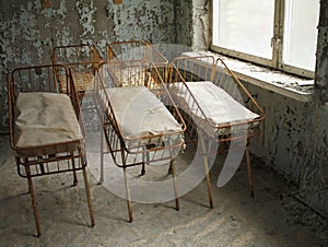 Beds for newborn babies in deserted hospital in Pripyat, Chernobyl, Ukraine.