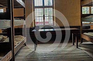 Beds and a small wooden table at the Auschwitz concentration camp in Poland