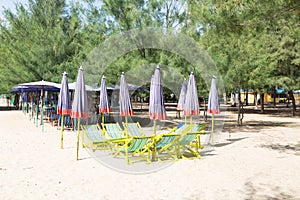 Beds and umbrellas on the beach.