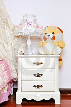 Bedside cabinet and lamp photo