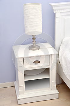 Bedside table with lamp photo