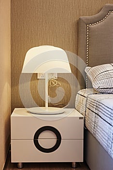 Bedside table Lamp in bedroom photo