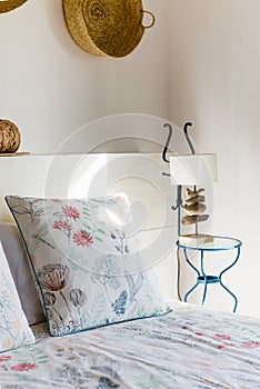 Bedside table with white lamp in the bedroom with vintage decor