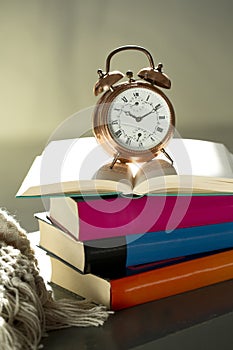 Bedtime reading, alarm clock and books