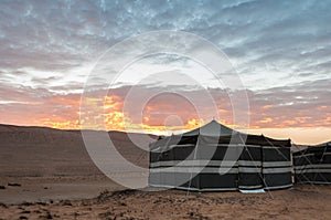 beduin tent camping on desert at sunset