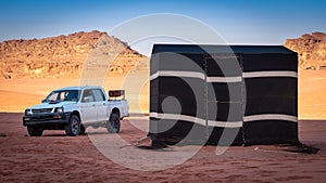 Beduin tents and offroad vehicle in Wadi Rum desert, Jordan