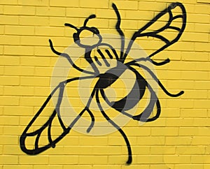 Bee Figure on Yellow Wall