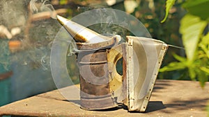 Bee maker of a smoke pipe beeper smoker device for repelling evil bees.