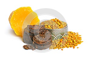 Bee pollen baskets with Propolis or bee glue and with Beeswax. Isolated on white background