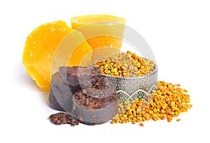 Bee pollen baskets with Propolis or bee glue and with Beeswax. Isolated on white background