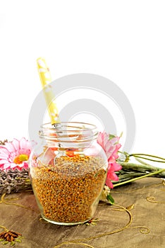 Bee pollen in glass jar and spoon