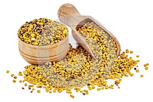 Bee pollen and wooden scoop on white