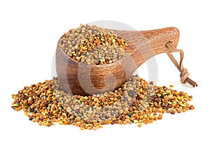 Bee pollen in wooden spoon isolated on white background, healthy food supplements. Dried healthy natural honey bee pollen.