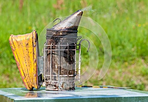 Bee smoker is a beekeeping tool for making smoke used to calm bees.