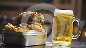 Beef Bacon Cheese Burger With French Fries And Beer With Bubbles