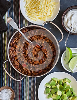 Beef and black bean chili on dark background