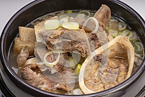 Beef bone marrow soup or Seolleongtang in hot iron pot, Beef Stock Bone, Marrowbone soup in hot iron pot Korean traditional food.