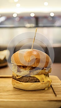 Beef brisket burger which contain bearnaise sauce, tomato, relish, onion rings and mozzarella cheese