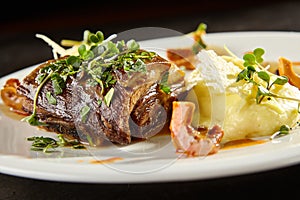 Beef brisket and mashed potato on white plate