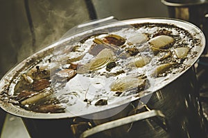 Beef broth boiling in a metal pot