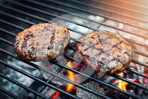 beef burger meat cooking on charcoal grill