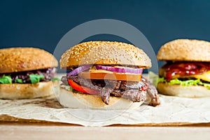 Beef burger with tomato, salad, onion, pepers and cheese