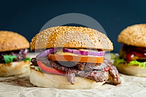 Beef burger with tomato, salad, onion, pepers and cheese