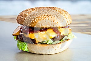 Beef burger with tomato, salad, onion, pepers and cheese