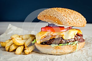 Beef burger with tomato, salad, onion, pepers and cheese