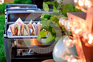 Beef burgers being served on street food stall. Summer burger catering